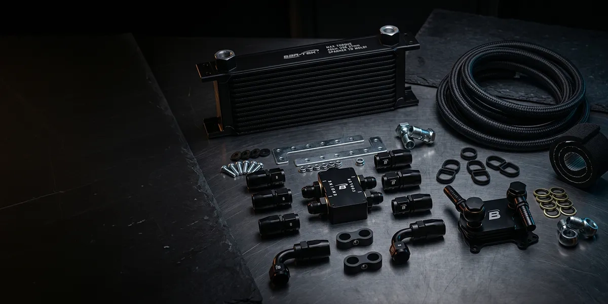Parts of the TDI oil cooler set on a dark background
